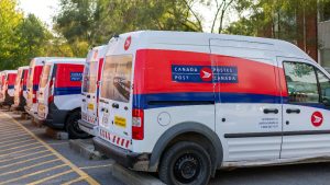 Canada Post trucks parked in a row.