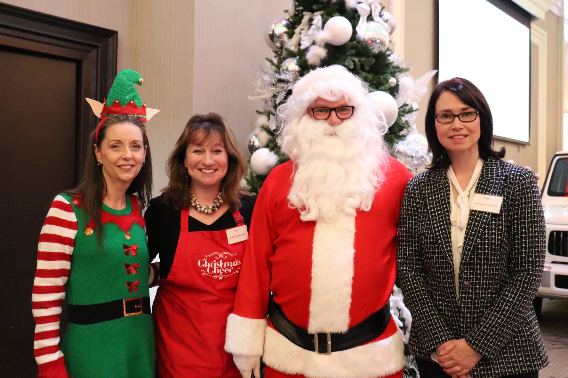 Christmas Cheer Foundation's Jennifer Van Noort (centre left) and Samantha Hamilton (far right) with Santa and his helper. (Photo by Mia Jensen)