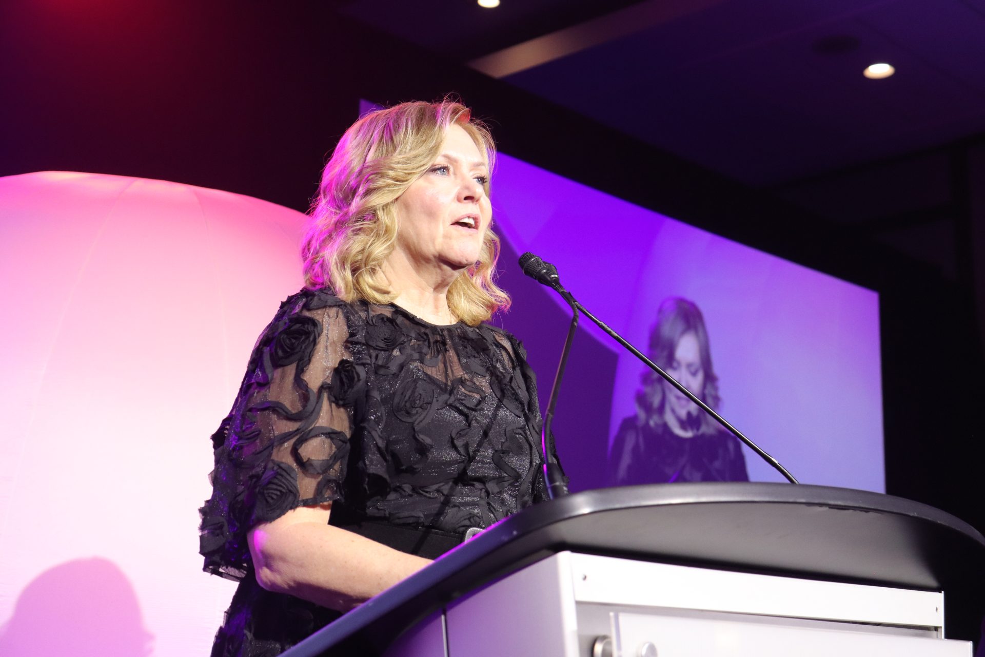 Krista Kealey accepts the 2024 Newsmaker of the Year award on behalf of Mark Laroche. (Photo by Mia Jensen)