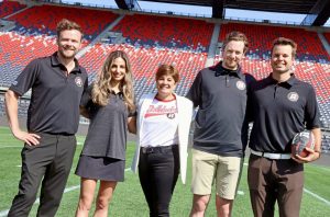 From left, Keaton Ambrose (Chandos Construction), Talia Silvestri (TD Bank), Lisa Nicholson (OSEG Foundation), Jonathan Gilman (Ottawa Interlock Repair) and Josh Raganold (Welch LLP), at TD Place Stadium to promote the Redblacks Summer Rush charity networking event happening Tuesday, August 27. Photo by Caroline Phillips