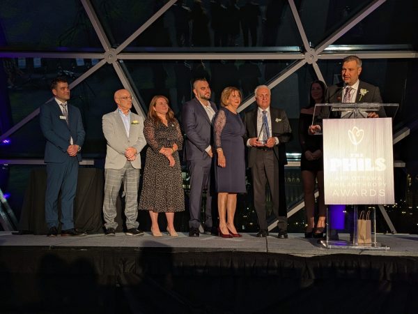 George Hanna, president and CEO of Gabriel Pizza, accepts the company's award for outstanding corporate philanthropist. Photo by Nickie Shobeiry.